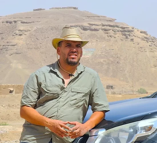 Moha the expedition tour guide wearring hat a background mountain