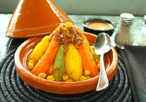 cooking tajin during cooking class itinerary in Morocco