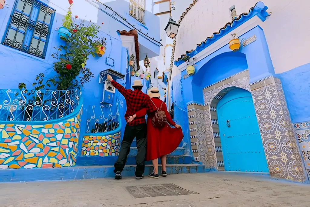 A couple wearing red in blue city in Morocco 