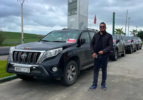 Moha our guide with a fleet of 4x4 vehicles