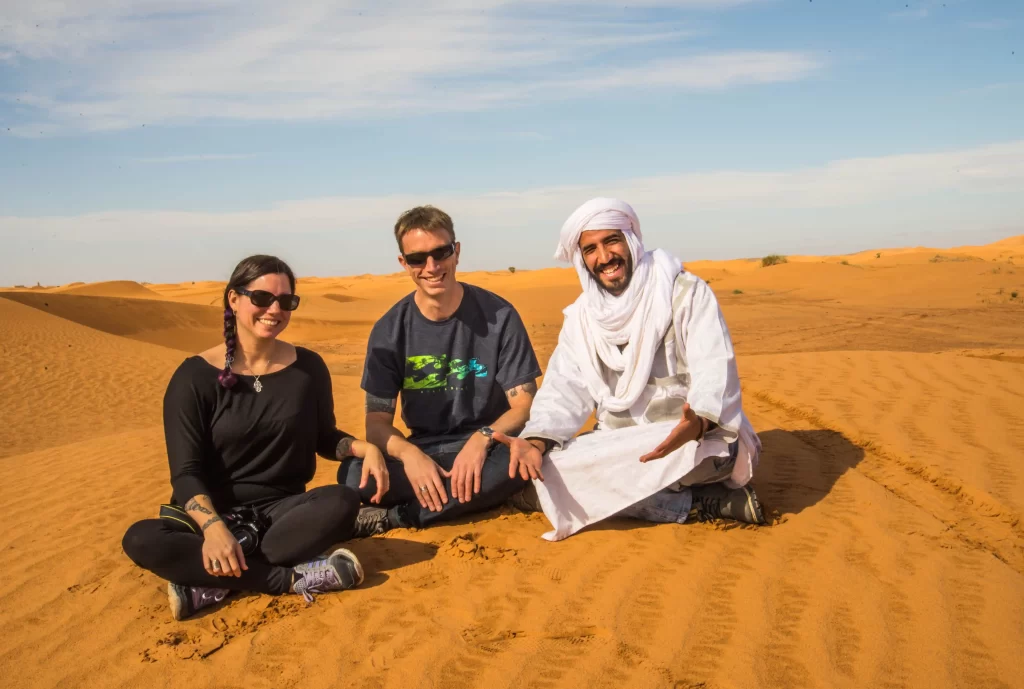 Tour guide Musti answering FAQs for travelers during a desert tour in Morocco with Enchanted Morocco Tours