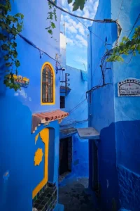 Narrow blue street in Chefchaouen medina with traditional Moroccan architecture during a 14-day Morocco itinerary