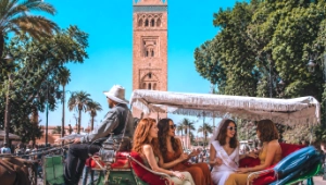 Bride-to-be celebrating a bachelorette trip with friends in a horse-drawn carriage in Marrakech, Morocco.
