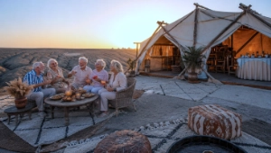 Group of friends celebrating retirement at a luxury desert camp in the Moroccan Agafay desert.